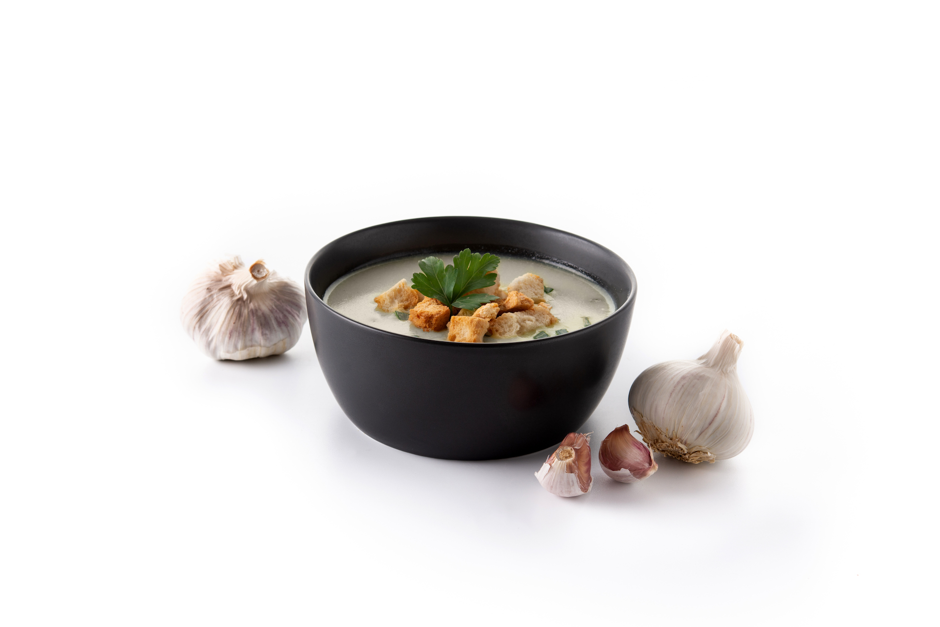 garlic-soup-topped-with-croutons-black-bowl-isolated-white-background