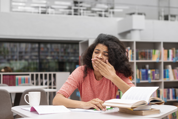 low-angle-girl-feeling-sleepy-library.jpg