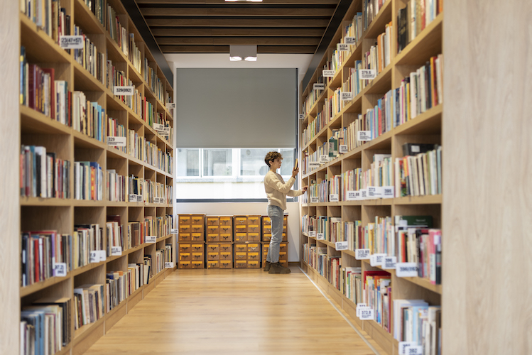 young-student-looking-book-library